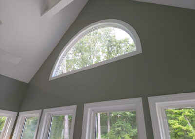 arched window inserted in the pitched ceiling