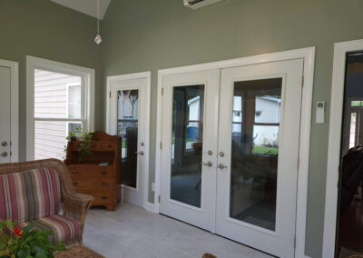 French doors and two single doors installed on the back wall of the house