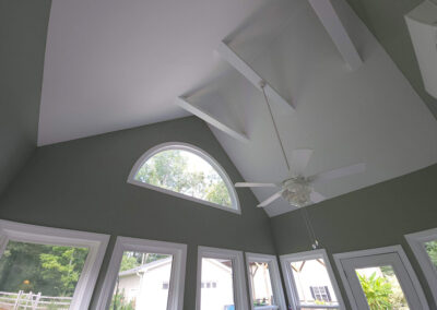 ceiling fan hangs from the custom rafters
