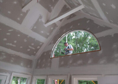 Handyman Mark workers install an arched window
