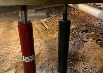 Floor jacks were used to support the sagging corner. A new footing had to be poured.