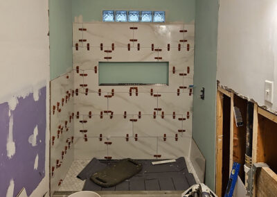mid-progress image of a custom bathroom tile installation project