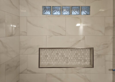Custom shower stall with window openings and bath product shelf