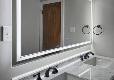 marble-topped vanity with powered, heated mirror