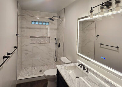 Fresh paint, new towel bars, and LVP flooring in a new bathroom renovation