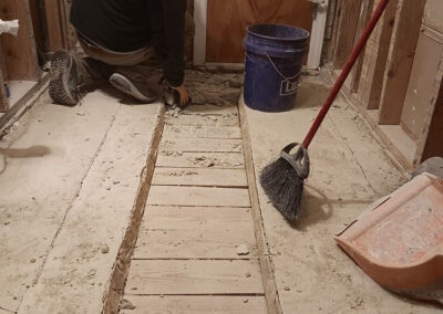 workman removing concrete floor